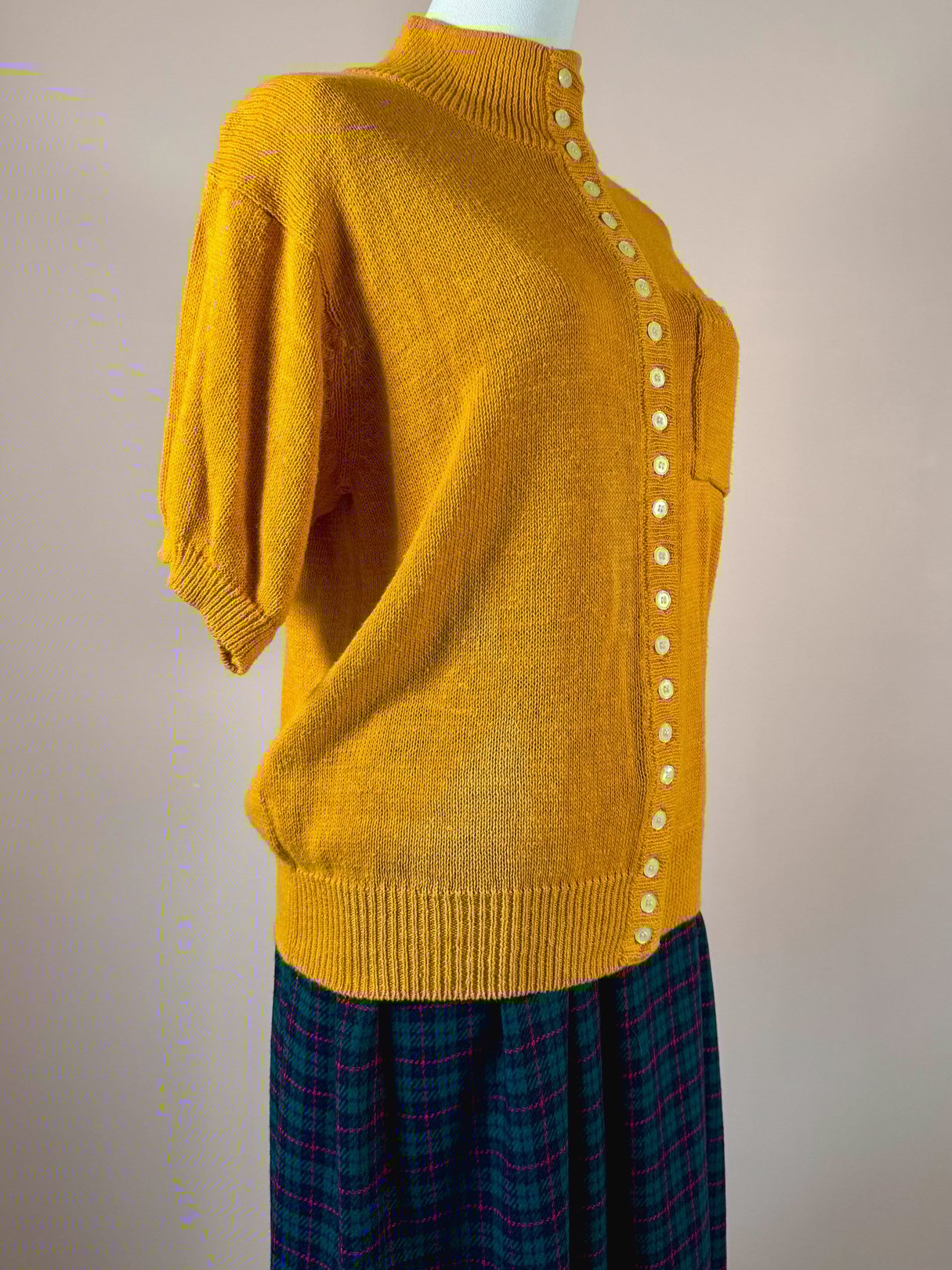 Persimmon orange women's sweater from the 1980s featuring a loose fit and button details along the side.