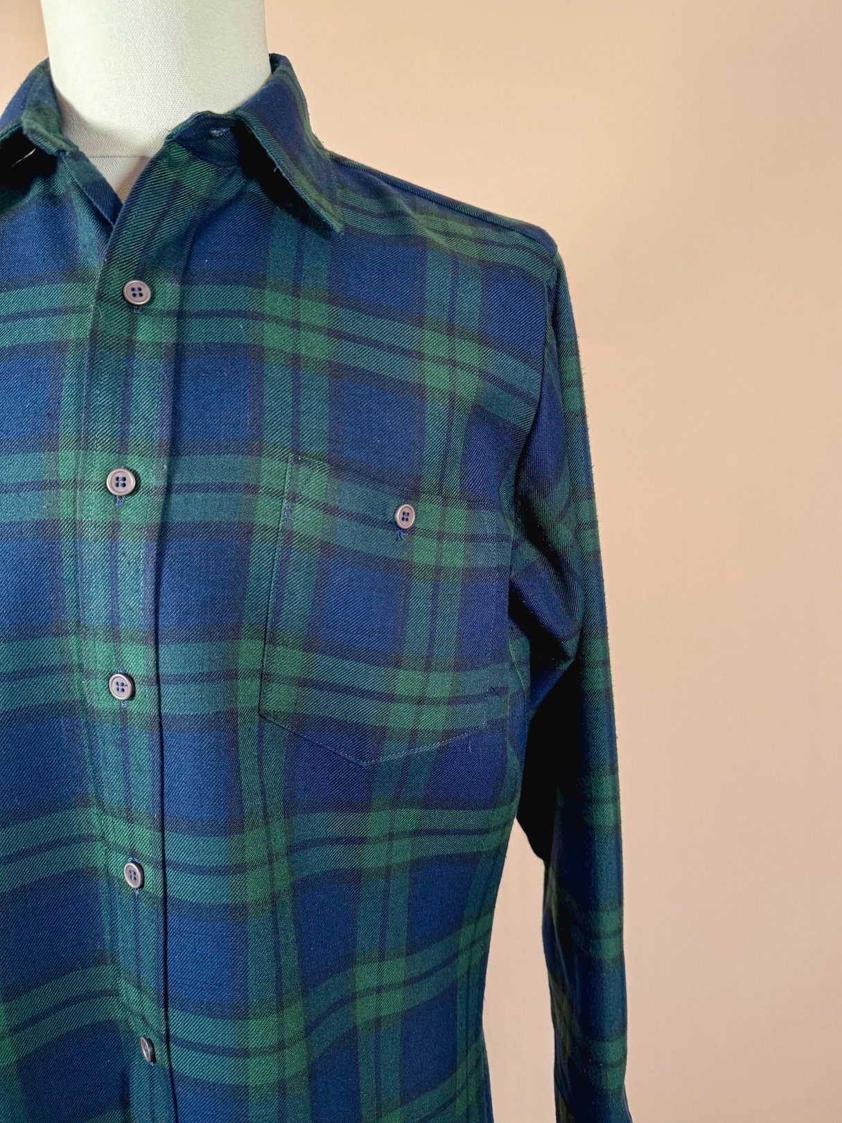 Navy blue plaid shirt for men featuring a button-up design and a single chest pocket, reflecting a 1950s style.