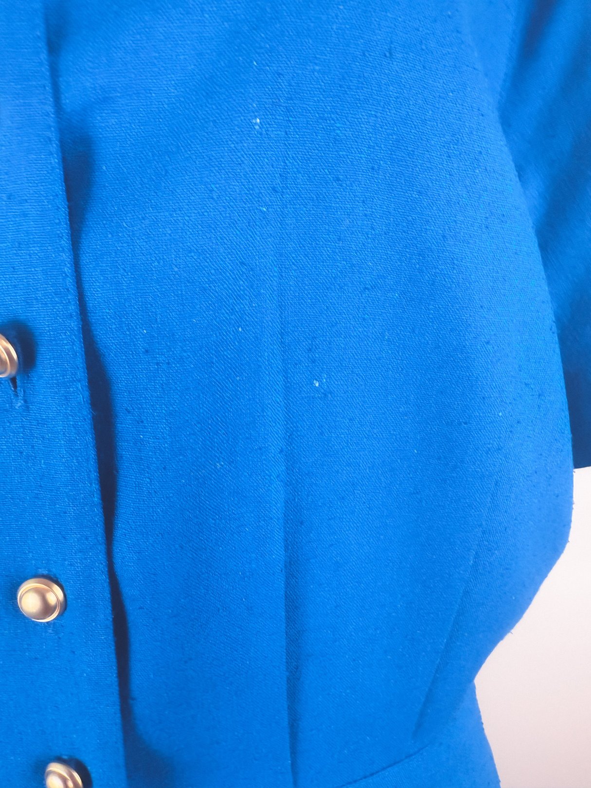 Cerulean blue 1980s women's dress featuring short sleeves and button detailing.