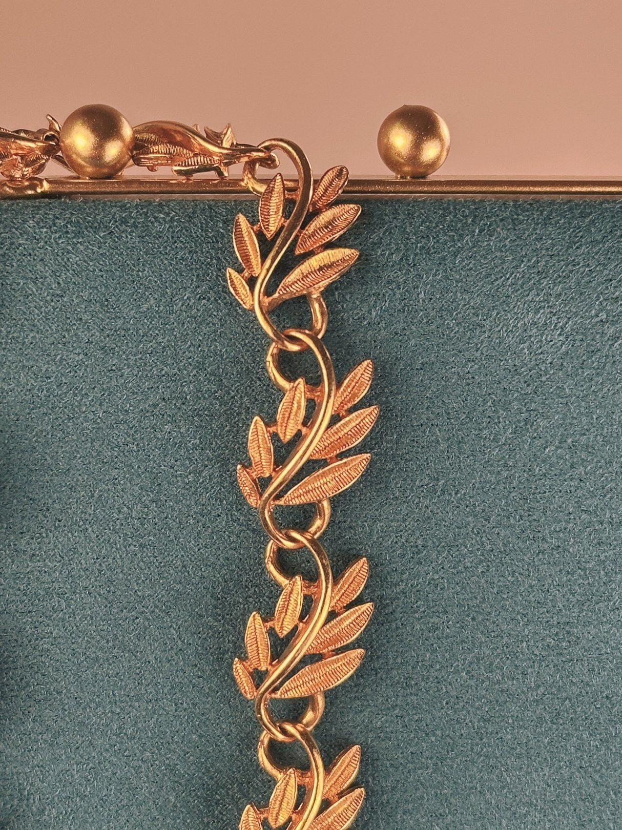 Gold tone collar necklace featuring a swirled vine design, typical of 1970s women's jewelry.