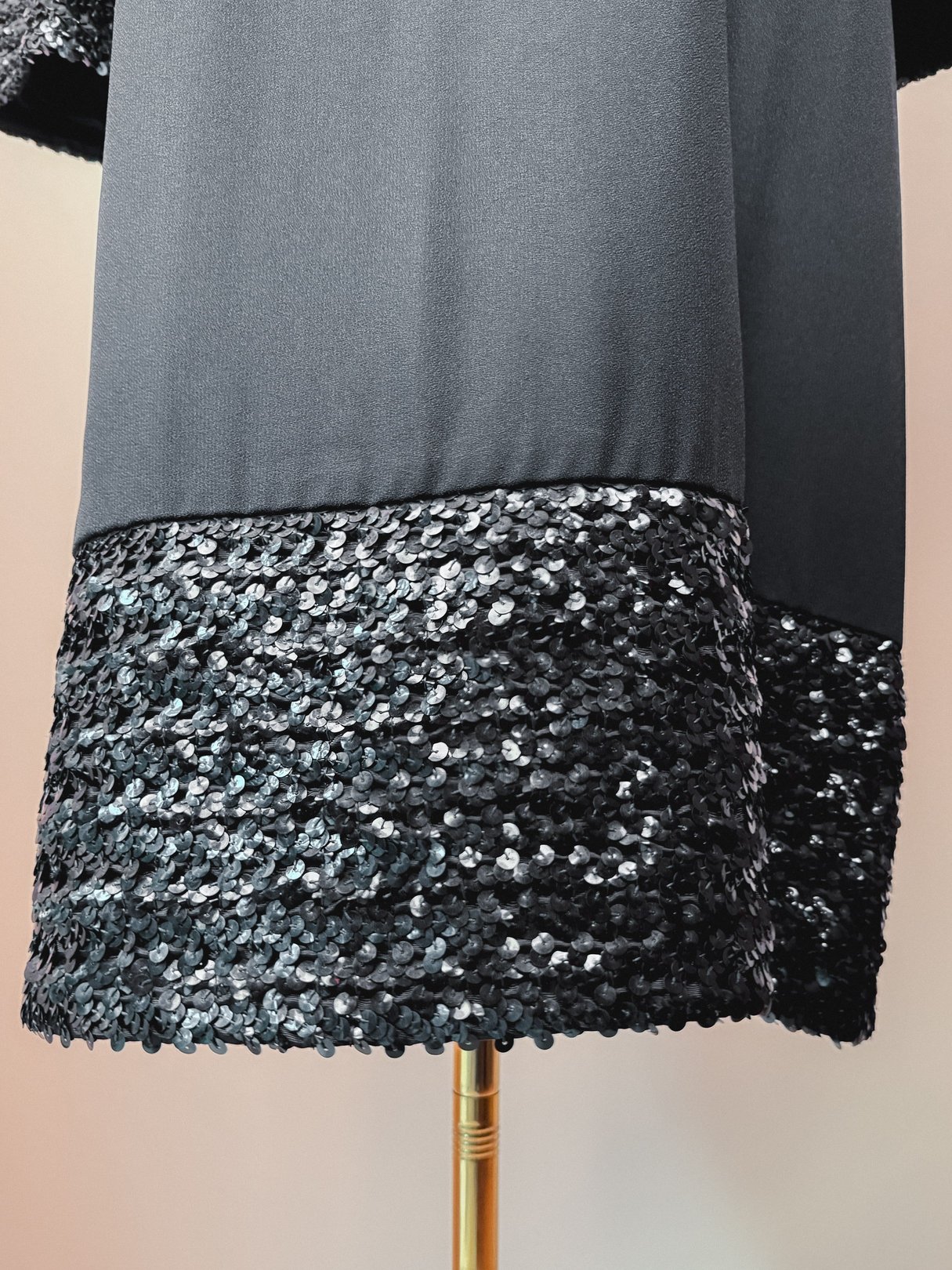 Black Mod Sparkle Dress featuring a sequined hem, indicative of 1960s fashion style.