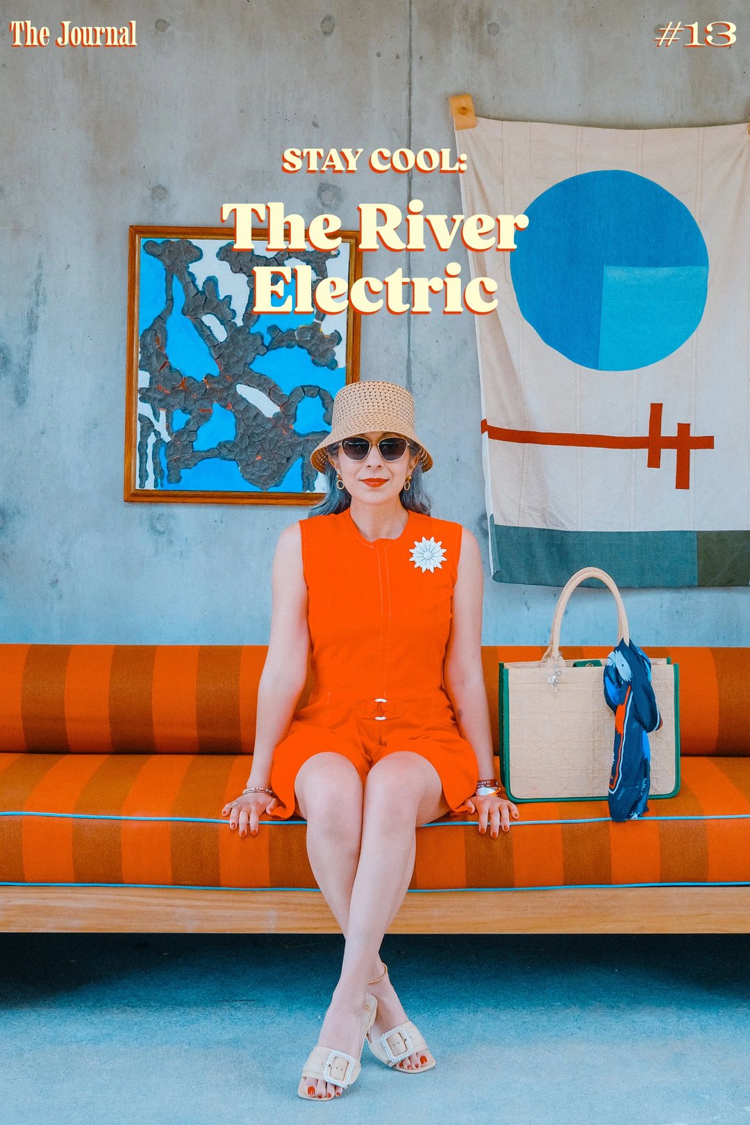 A woman in a bright orange dress and sunglasses sits on a striped couch with a tote bag, featuring a decorative wall with art pieces behind her.