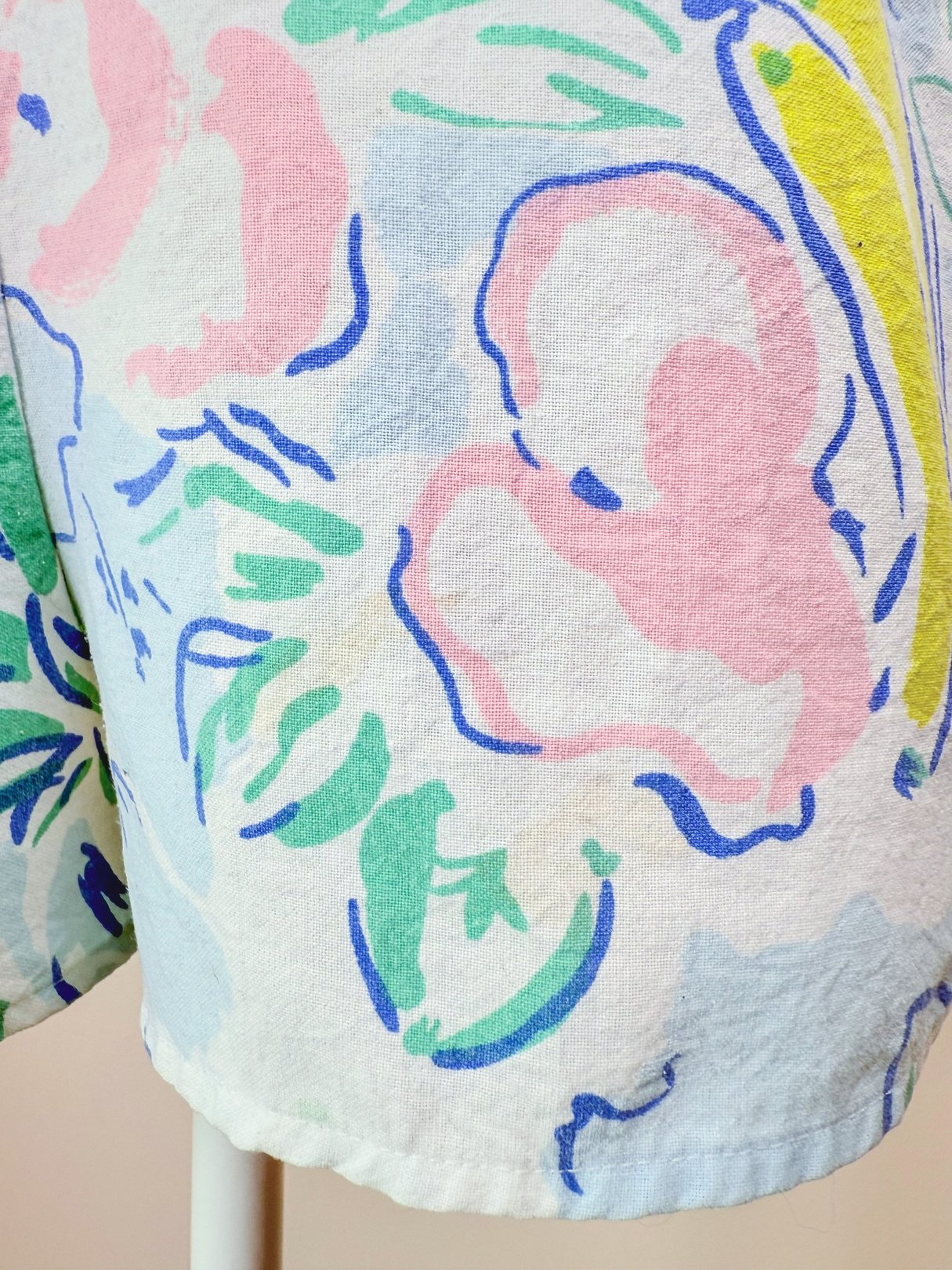 Blue 1980s women's romper featuring a colorful floral pattern.