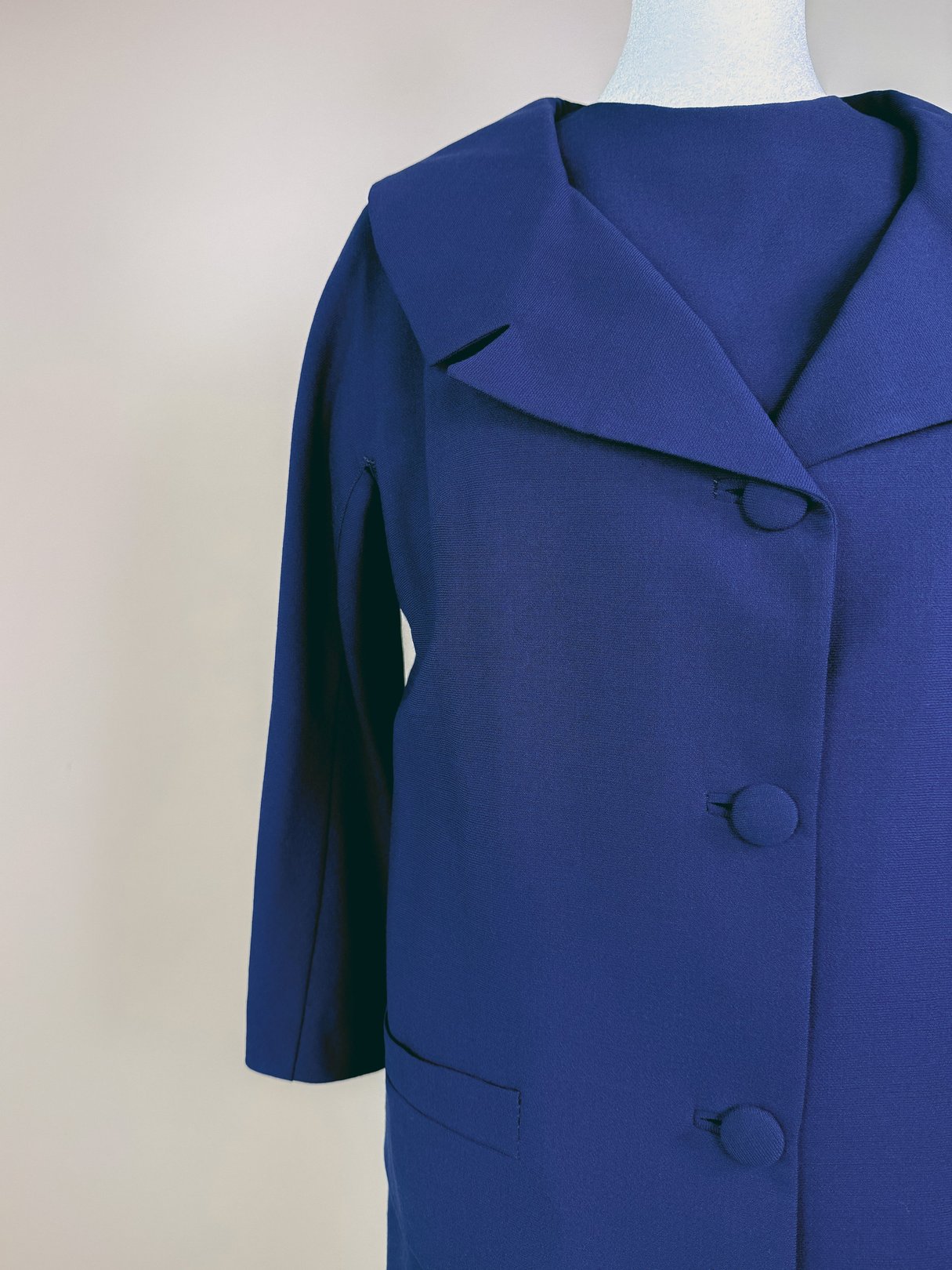 Navy blue 1960s women's dress set featuring a coat with a large collar and button closure.
