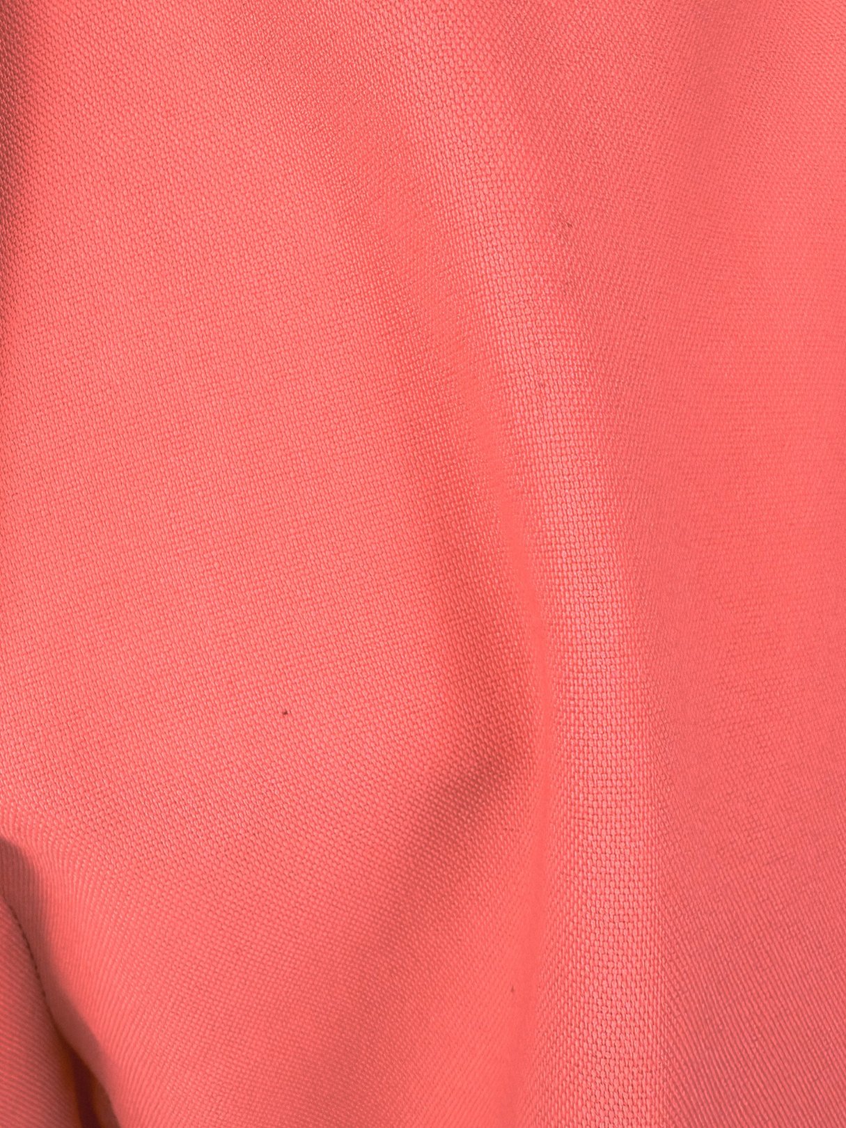 Coral pink fabric swatch of women's 1970s-style pants.