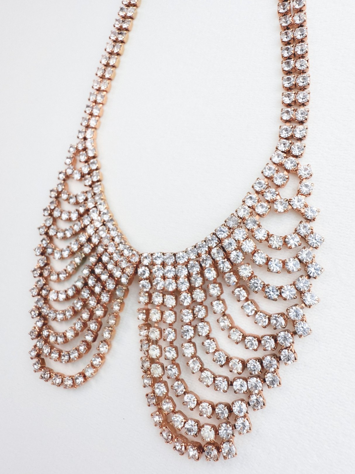 Gold collar necklace featuring cascading rows of sparkling rhinestones in a 1970s style.