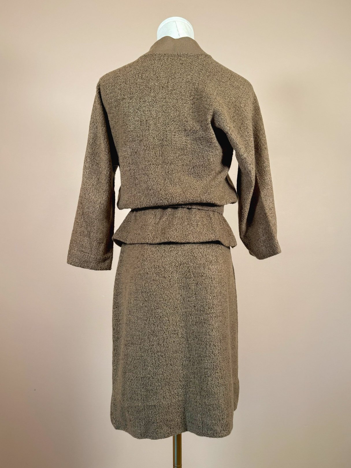 Brown 1950s Jantzen Hearthside knit set for women featuring a fitted jacket with long sleeves and a matching knee-length skirt.