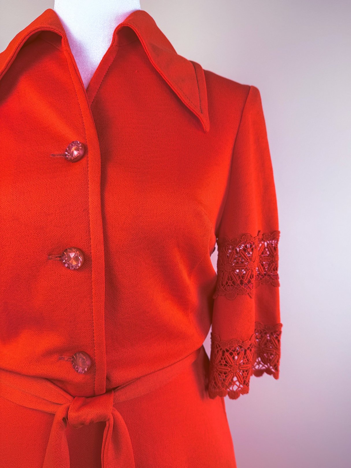 Red Cherry Lace Bell Dress with a collared neckline, three decorative buttons, and lace detailing on the sleeves, typical of 1970s fashion.