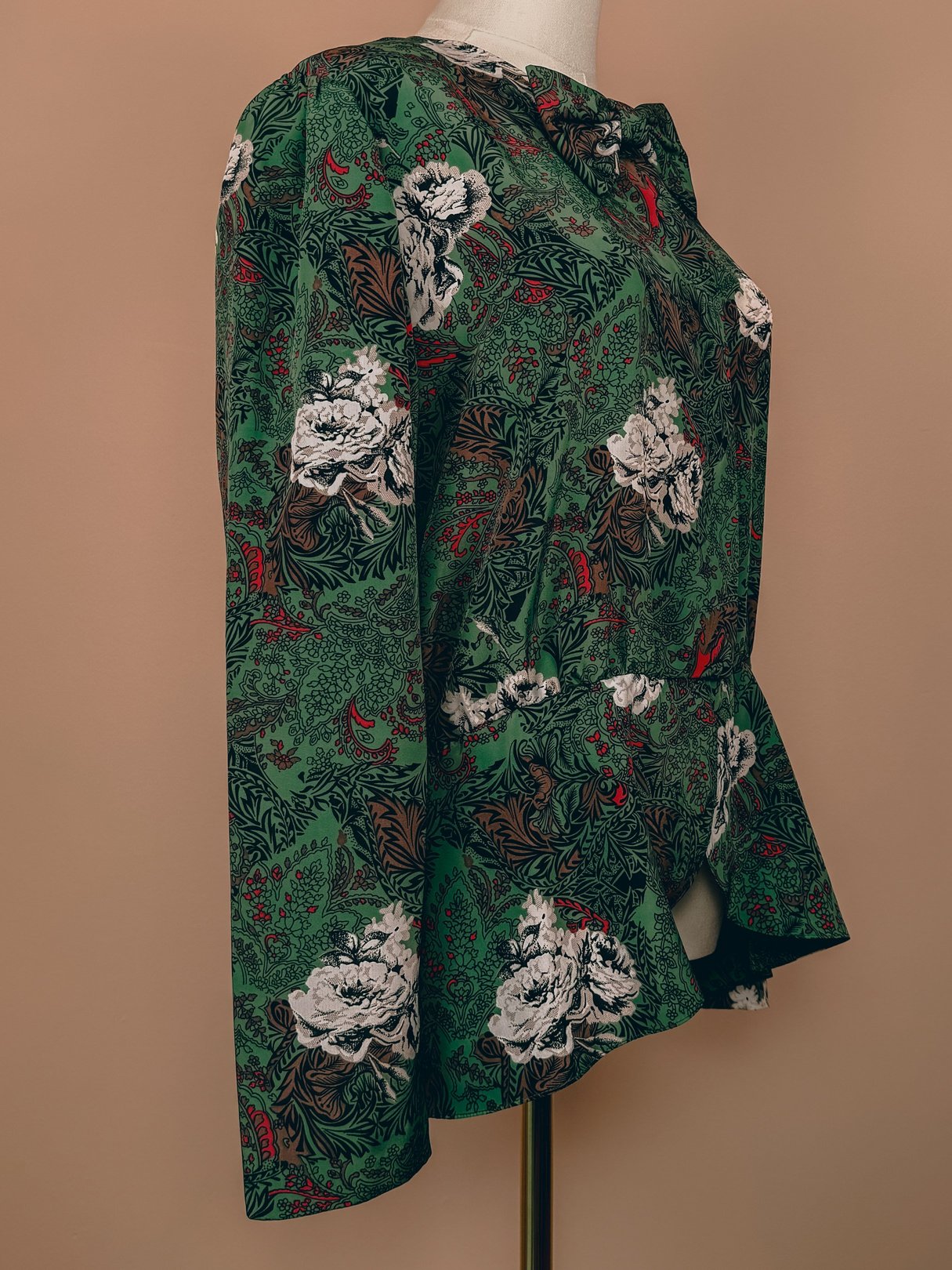 Red floral patterned women's bow top from the 1980s, showcasing long sleeves and a peplum waist.