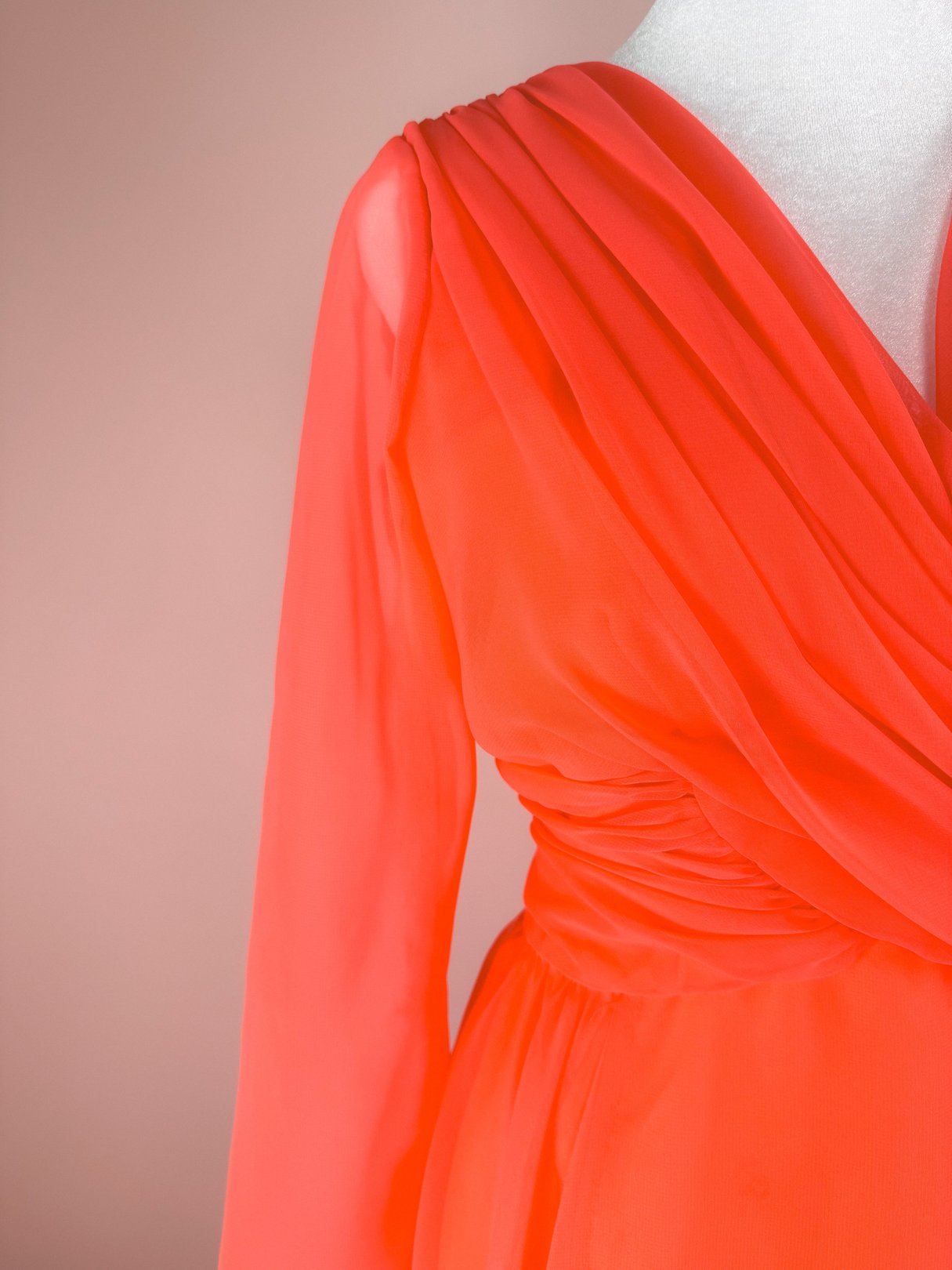 Coral Soirée Dress featuring a draped bodice and long sheer sleeves, typical of 1960s women's fashion.