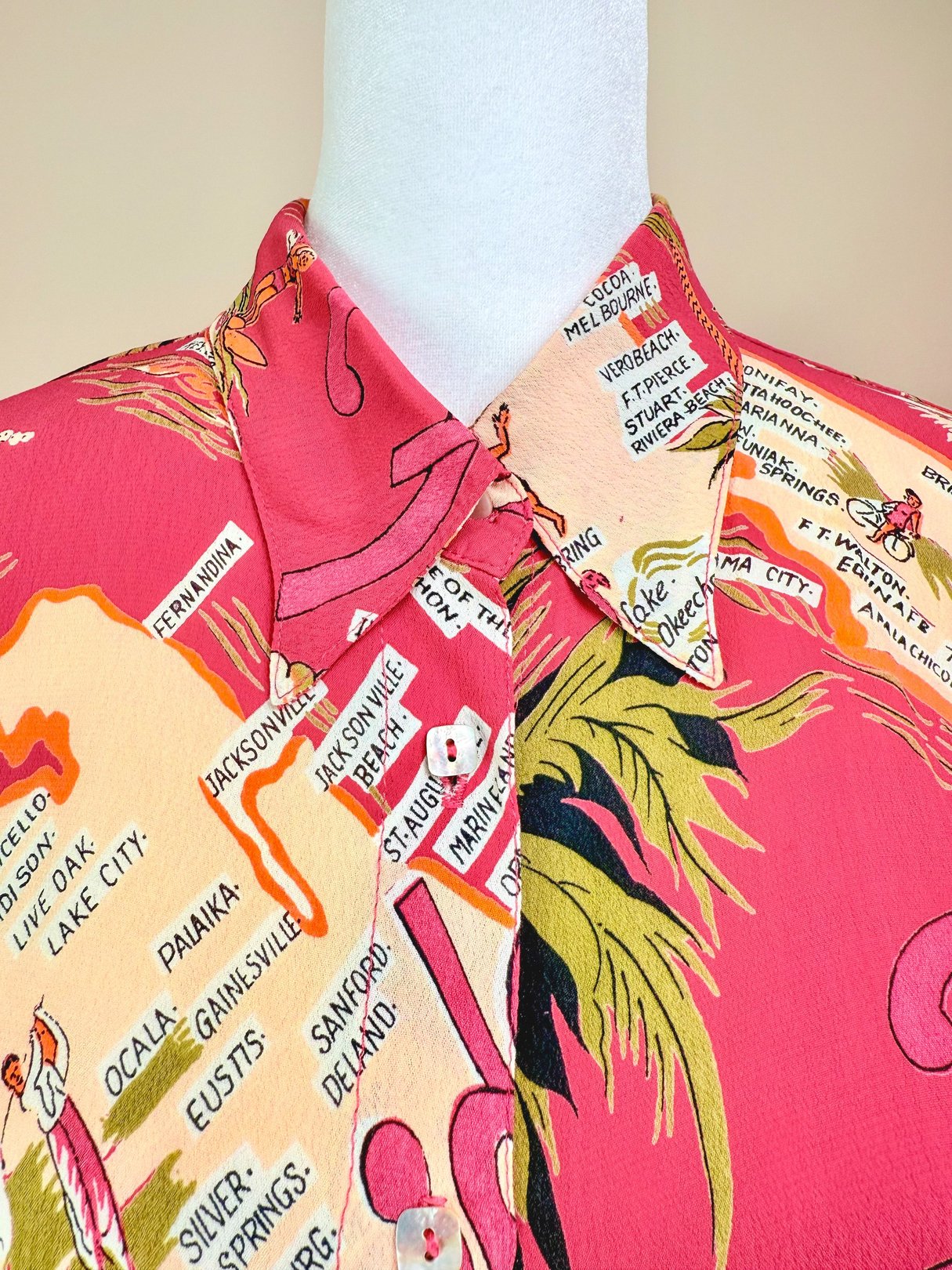 1970s women's white top featuring a colorful map print of Florida and palm trees.