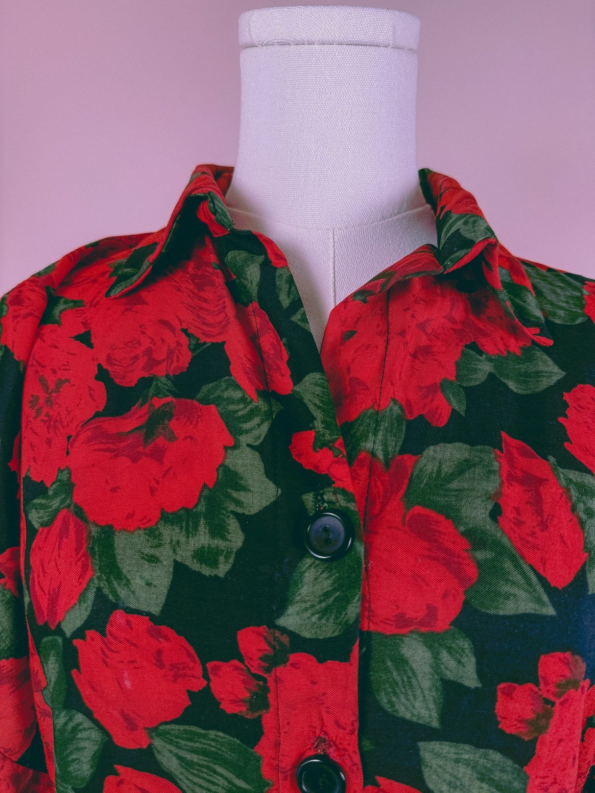 Red floral dress featuring a collared neckline and button closure, inspired by 1990s fashion.