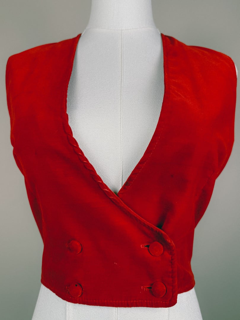 Red 1970s women's vest with a deep V-neck and double button closure.