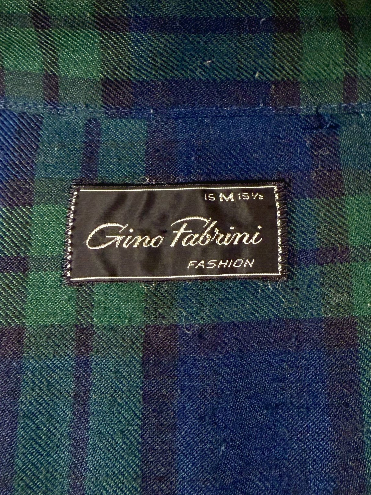 Gino Fabrini Forest Plaid Shirt label featuring navy blue and green plaid pattern, indicating men's fashion from the 1950s.