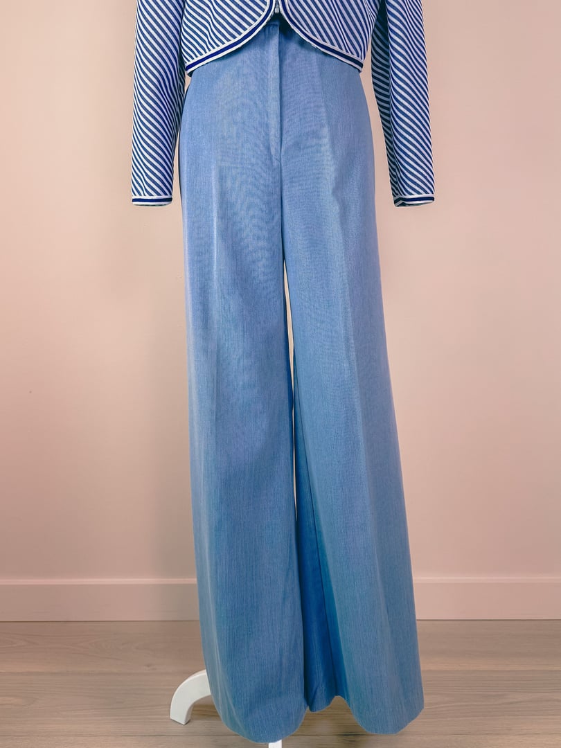 Light blue women's pants from the 1970s, featuring a wide-leg design and displayed on a stand.