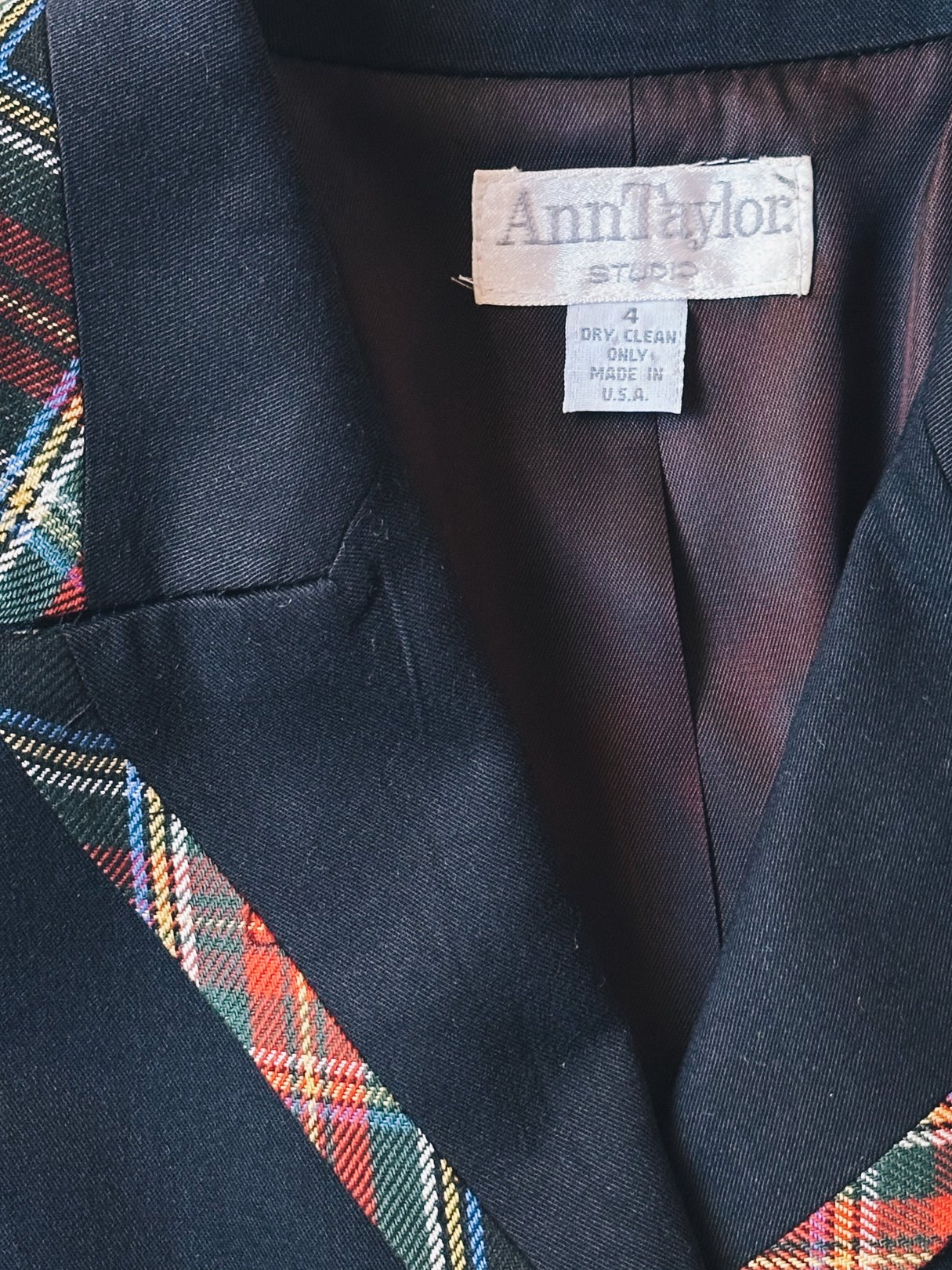 Black plaid suit jacket with multicolored tartan accents, featuring a label that reads "Ann Taylor.