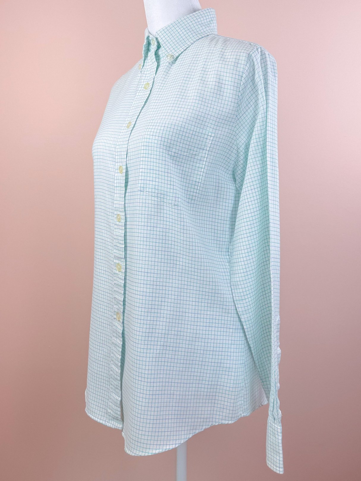White checkered button-down shirt for women with a relaxed fit and long sleeves, featuring a classic collar and button closure, reflecting a 1980s style.