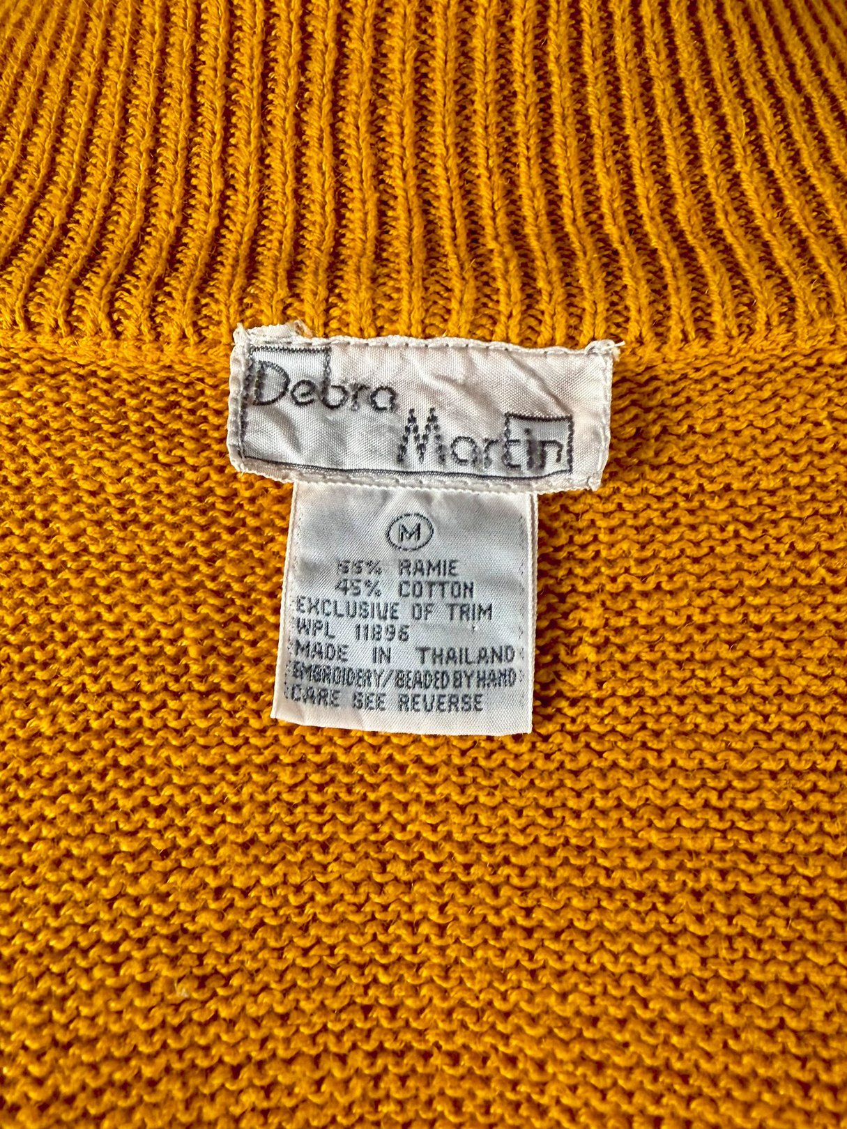 Persimmon orange 1980s women's sweater with a label indicating it is made of 75% ramie and 25% cotton.