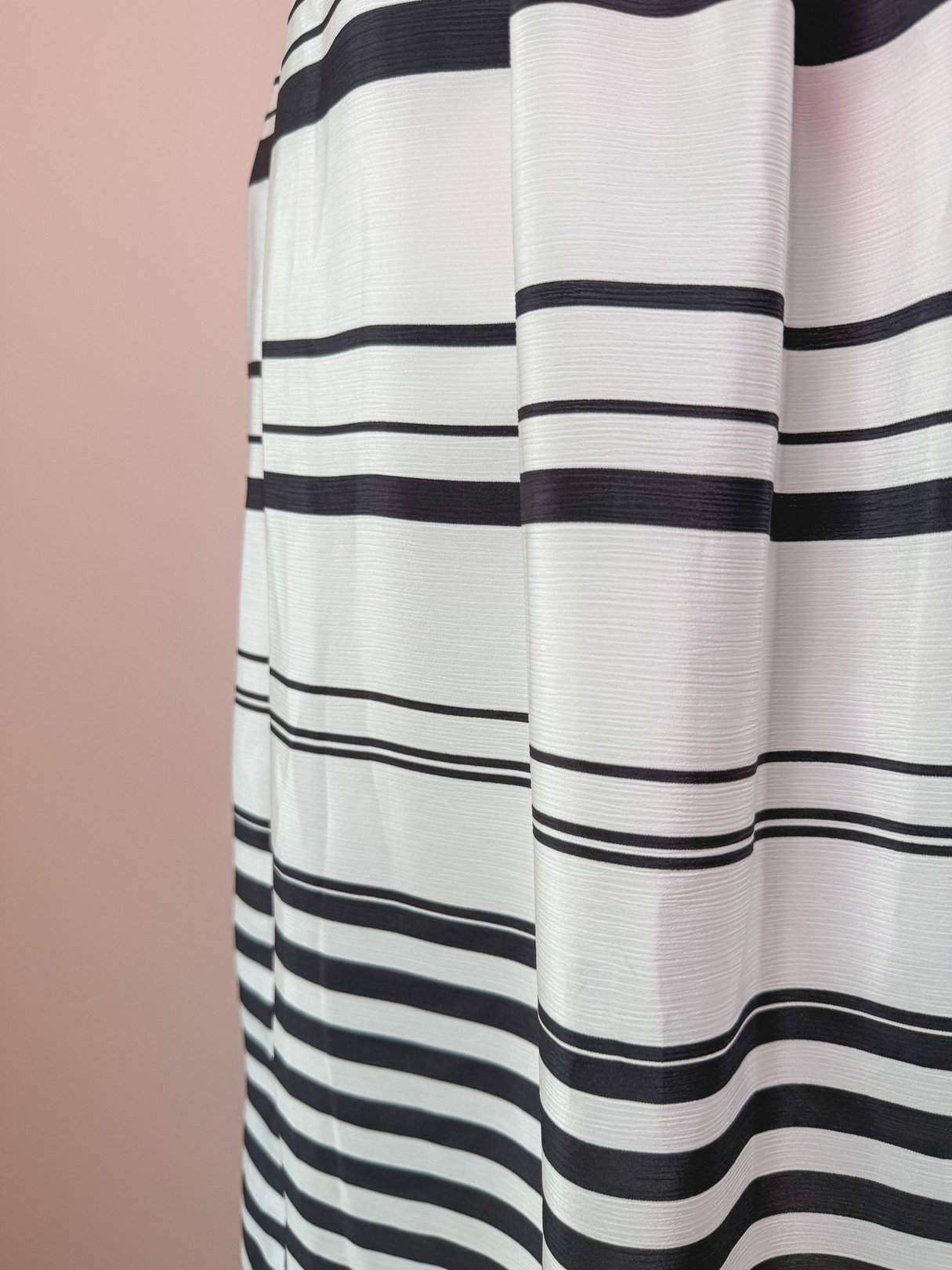 White skirt with black stripes, reflecting a 1970s style design for women.