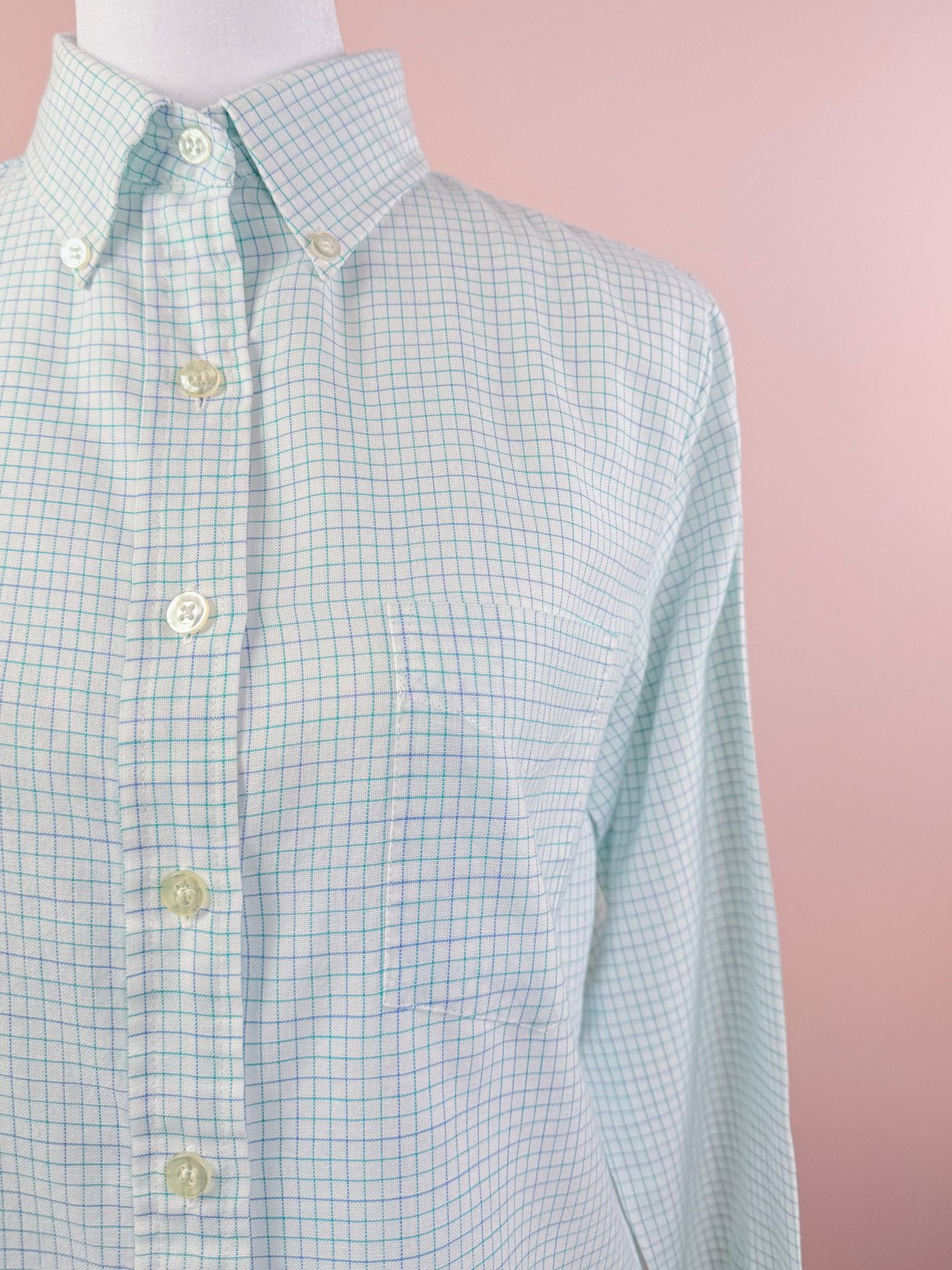 Preppy checkered button down shirt for women in white with light blue and green grid pattern from the 1980s.