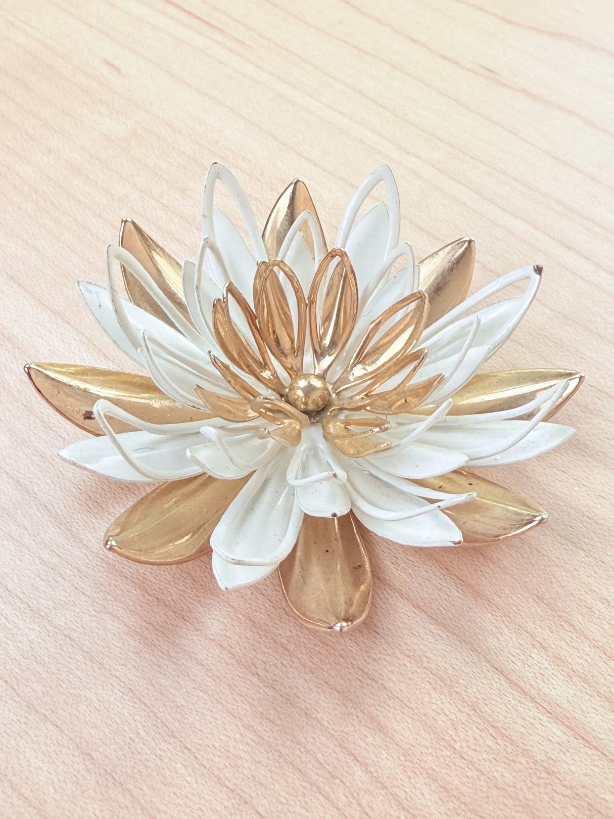 A decorative lotus flower sculpture featuring white and gold petals.