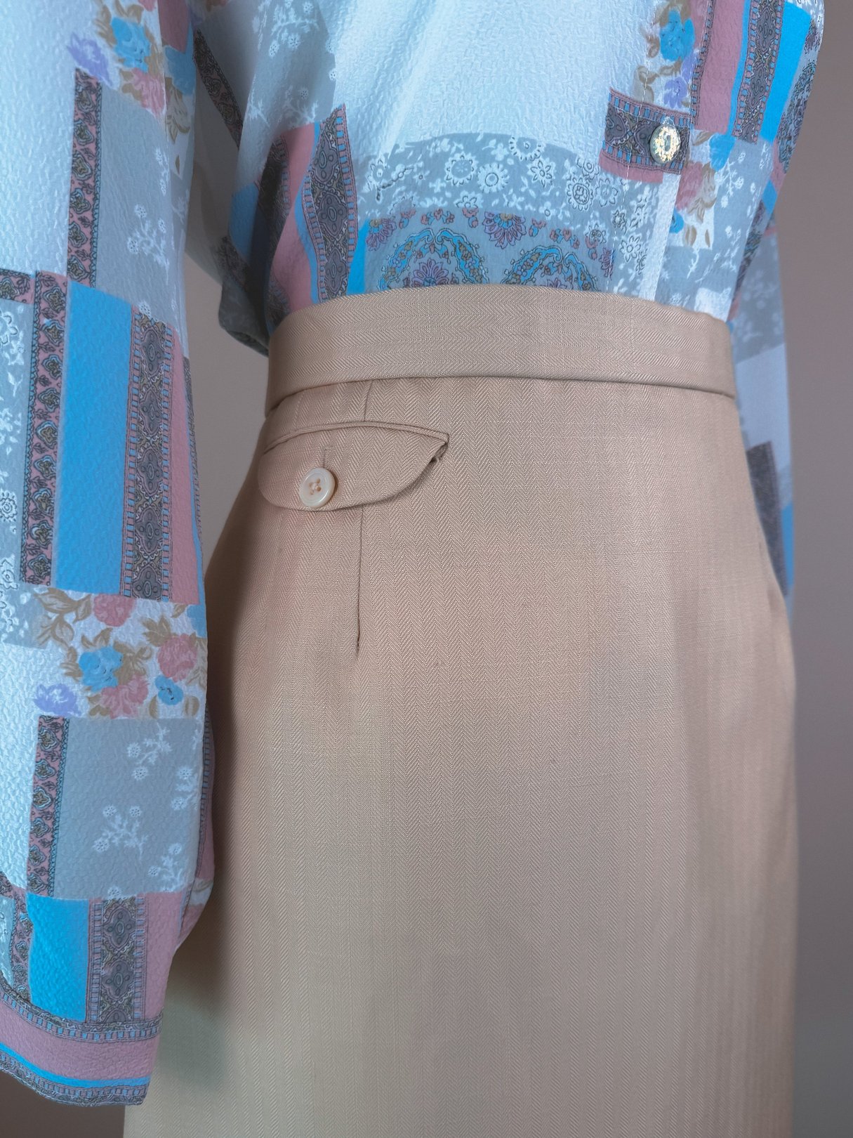 Cream beige 1960s women's skirt with a button detail at the waist.