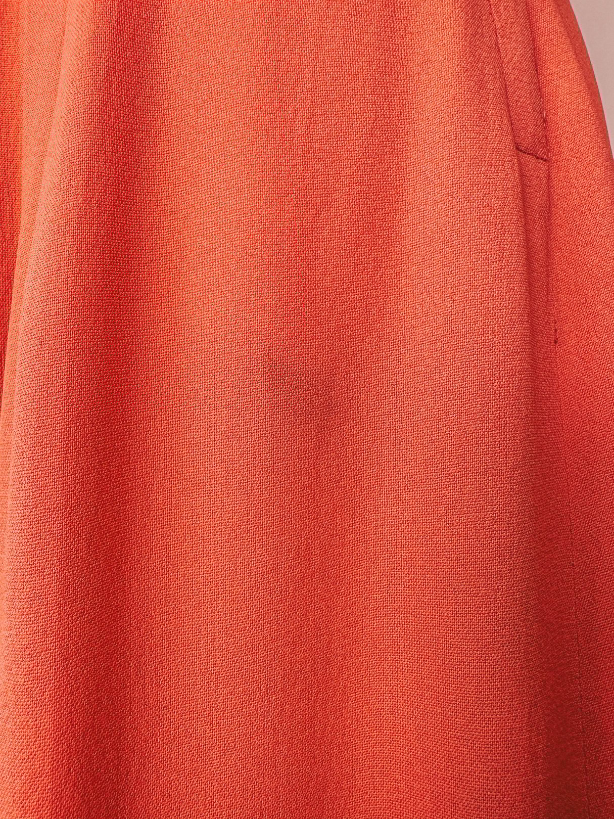 1940s coral Recital dress featuring a textured fabric and a flattering silhouette.