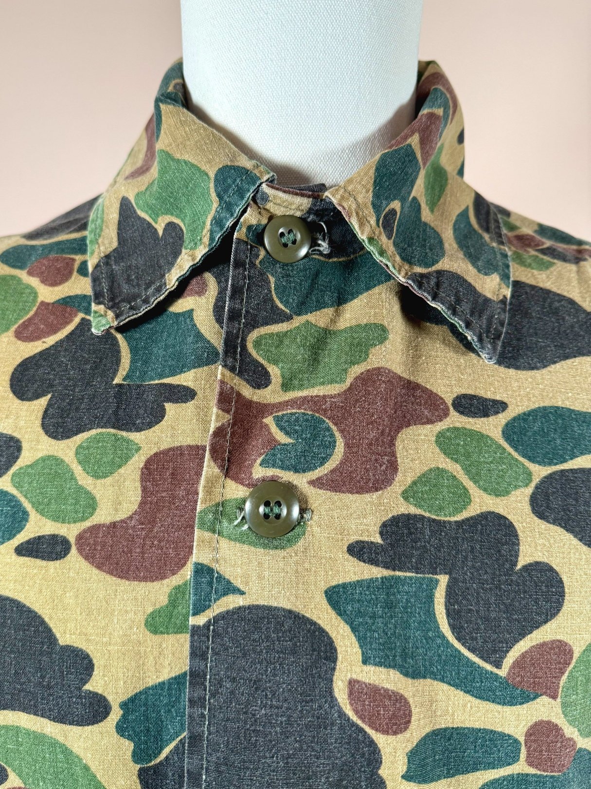 1970s men's Jim "Catfish" Hunter camo jacket featuring a camouflage green pattern with buttons at the collar.