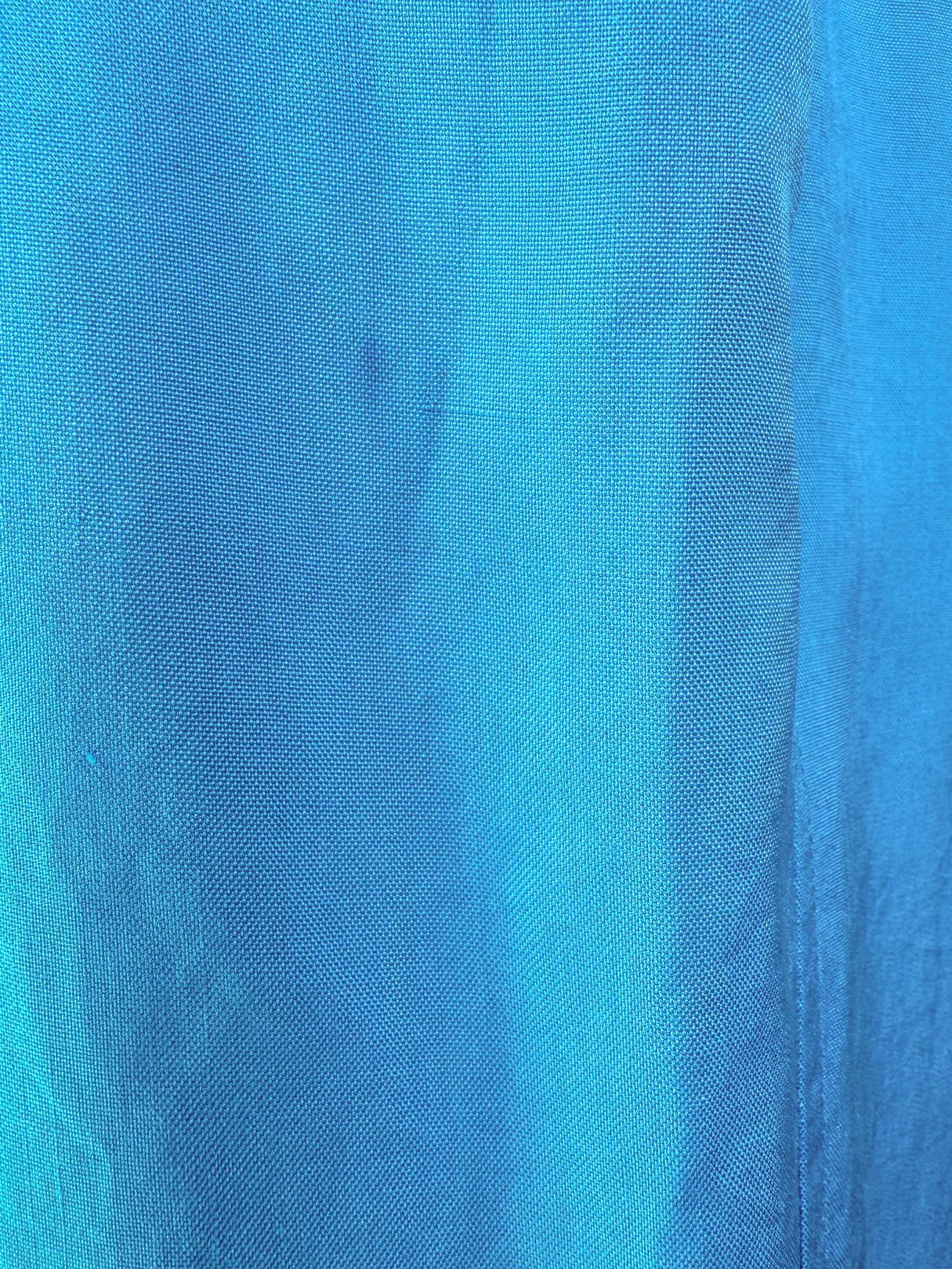 Turquoise blue fabric of a women's skirt from the 1980s.