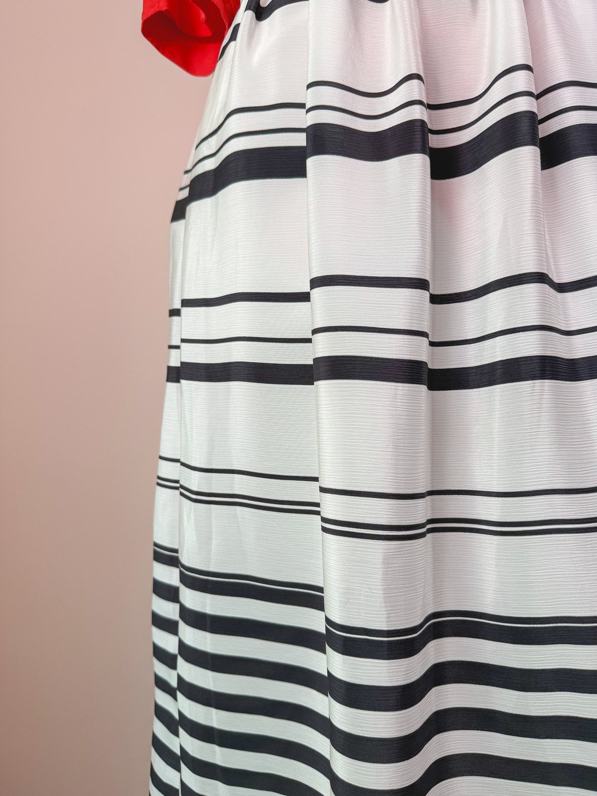 White 1970s women's skirt featuring horizontal black stripes.