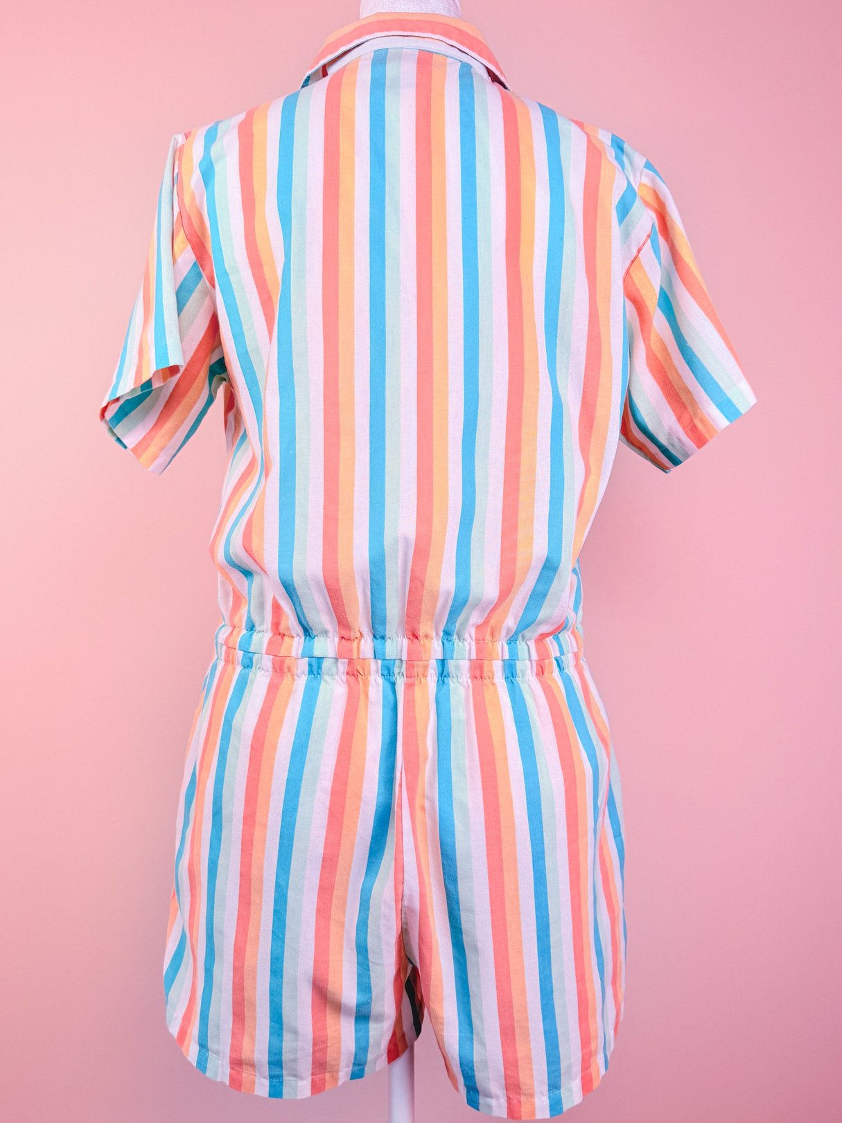 1980s women's Club Cabana romper featuring a multicolored striped pattern in blue, pink, orange, and white.