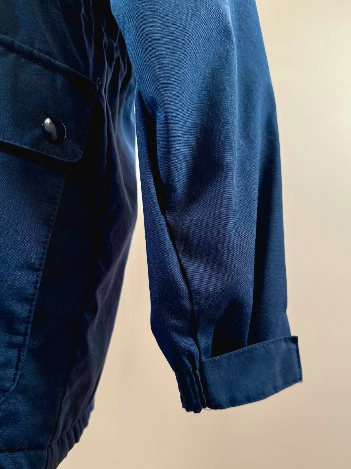 Navy blue women's utility field coat from the 1970s showcasing a cuffed sleeve.