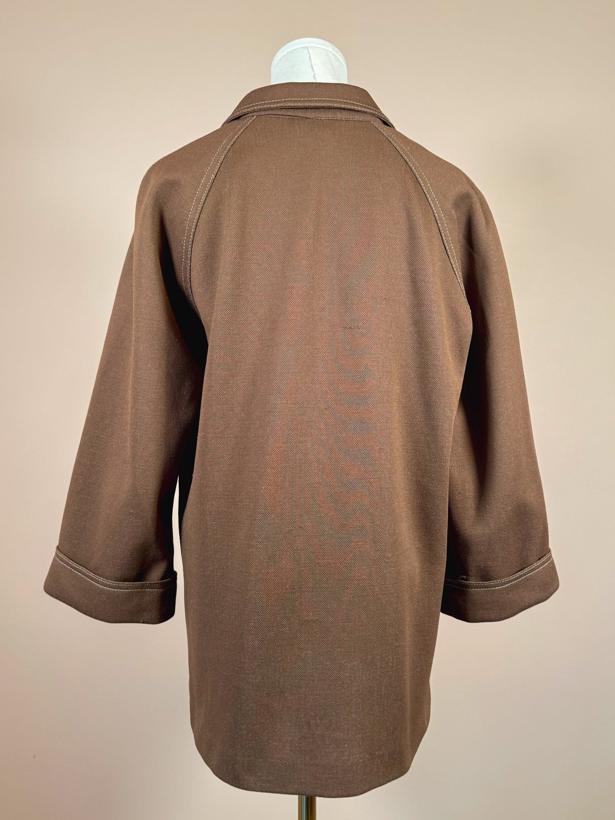 Brown 1960s women's chestnut jacket with a relaxed fit and three-quarter sleeves, displayed on a mannequin against a neutral background.