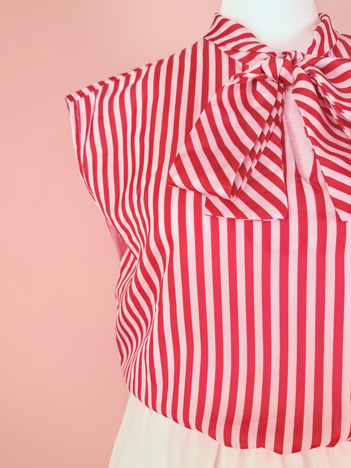 Red and white striped women's dress from the 1970s featuring a high neck and bow tie detail.