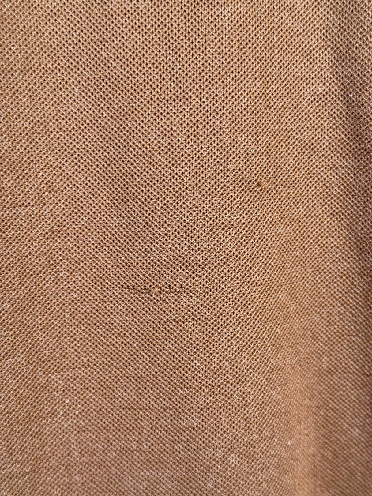 Brown textured fabric of a 1960s women's chestnut jacket.