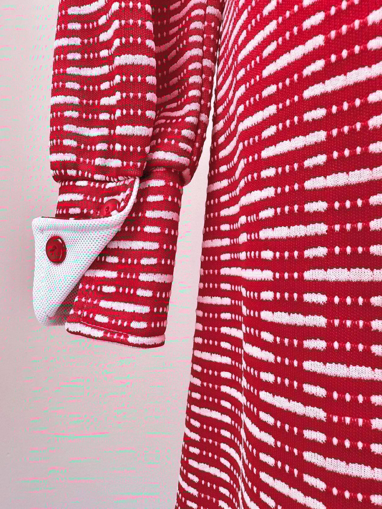 Red 1970s knit dress for women featuring a textured pattern with white stripes and a buttoned cuff.