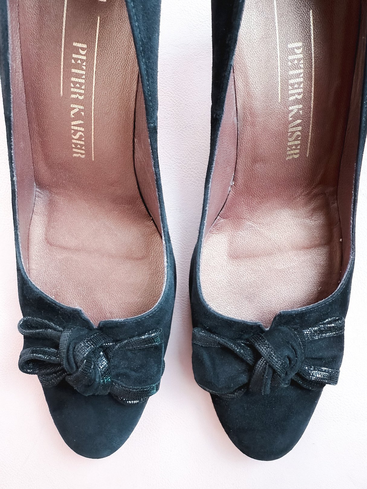 Black suede women's pumps from the 1970s featuring a decorative bow detail on the front.