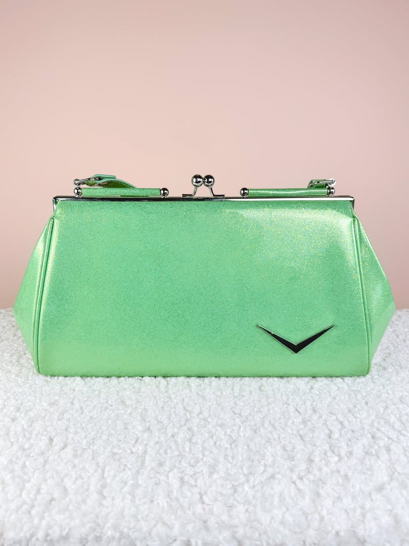 Sparkling mint green 1950s handbag with a clasp closure and a silver accent.