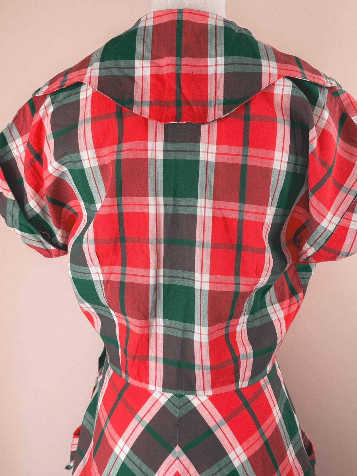 Red plaid dress with a 1950s silhouette featuring a wide collar and short sleeves.