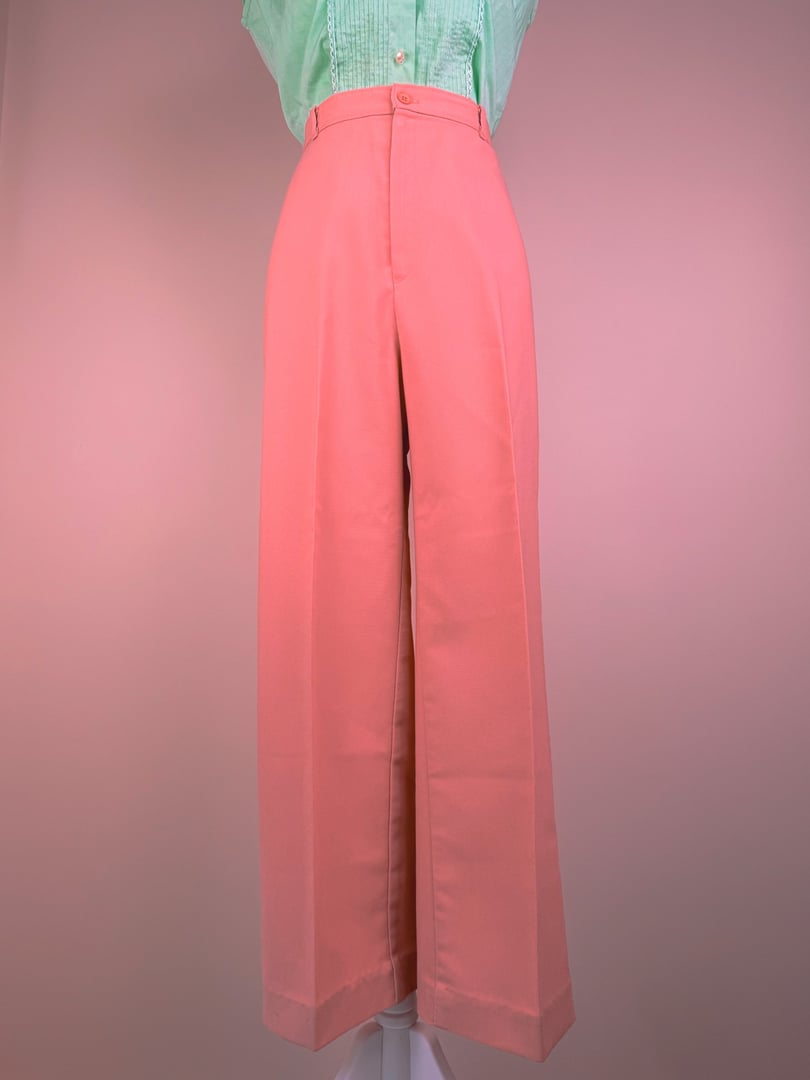 Coral pink wide-leg pants for women, styled in a 1970s era.