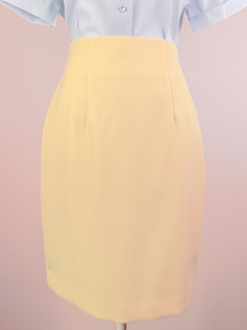 Buttery yellow 1990s women's skirt featuring a fitted silhouette and subtle pleats.
