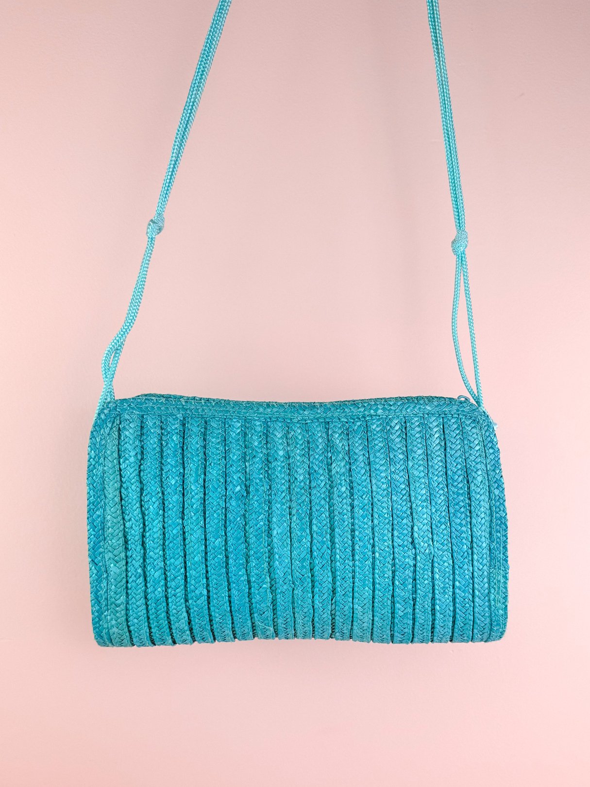 Teal blue woven shoulder bag with a ribbed texture, designed for women in the 1970s.