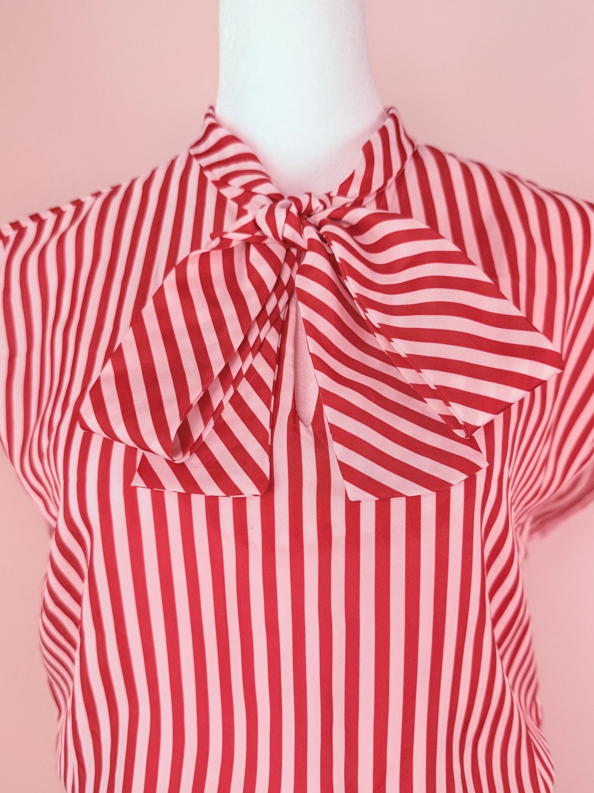 Red 1970s Candy Stripe Dress with a bow tie at the neckline and vertical stripes.