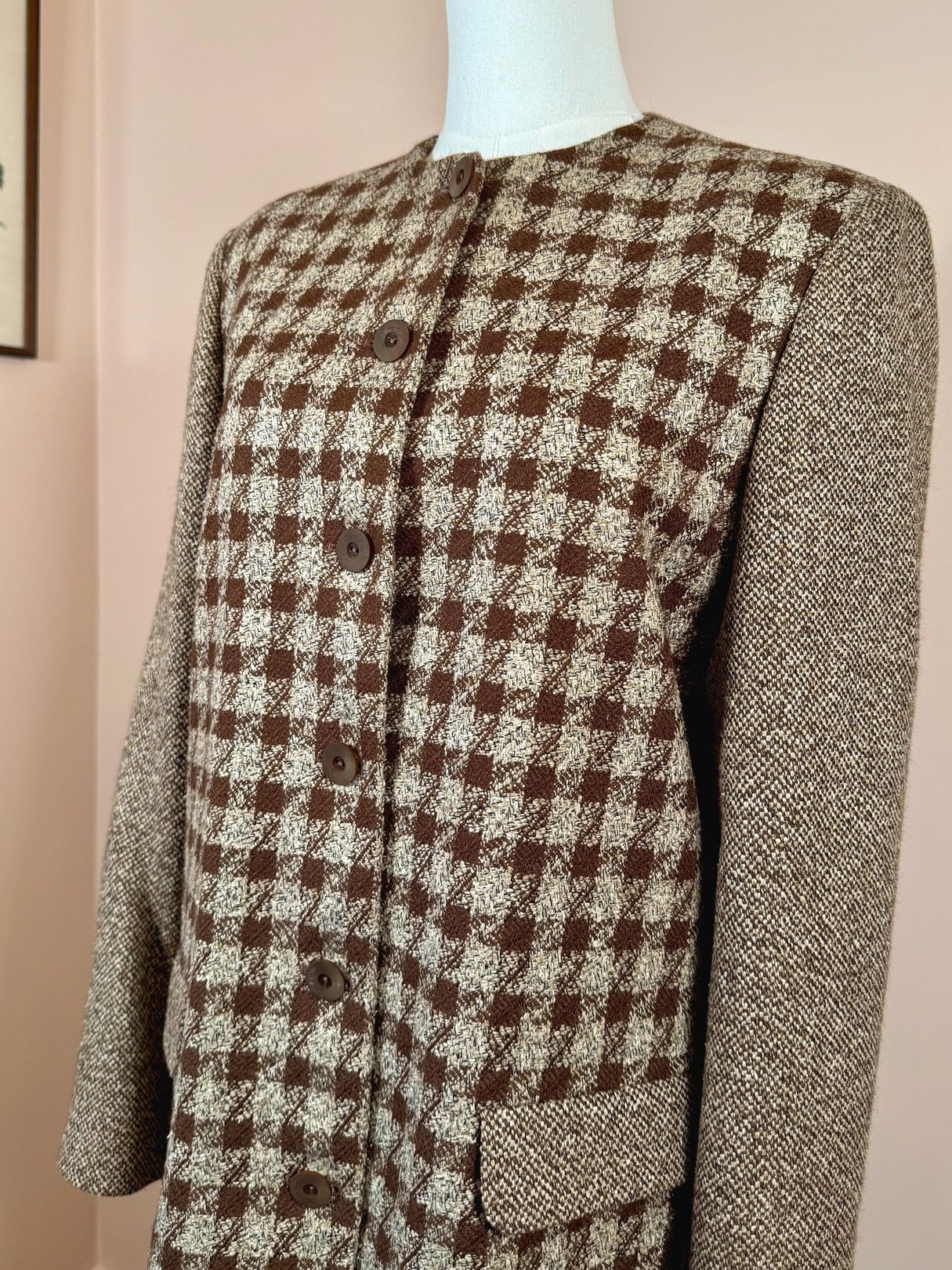 Brown tweed coat with a checkered pattern, featuring a round neckline, long sleeves, and button closure, designed for women in the 1990s.
