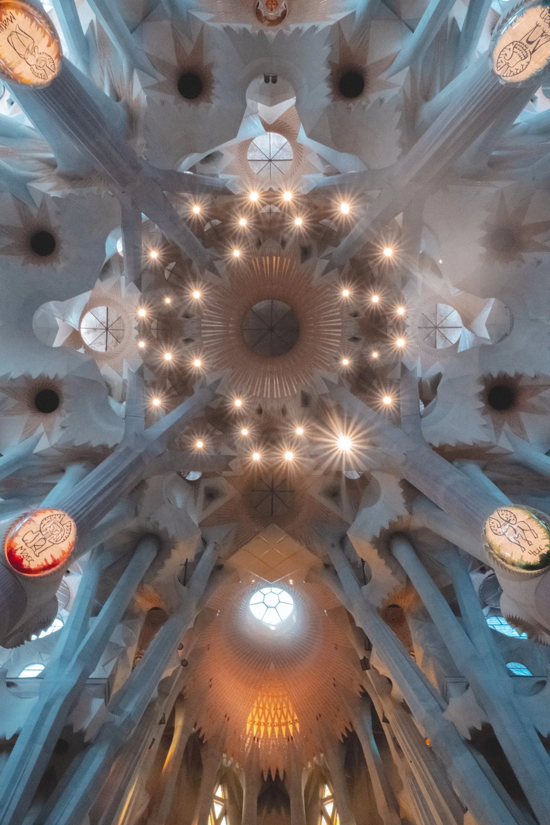 The interior ceiling of a futuristic cathedral features intricate designs and illuminated elements.