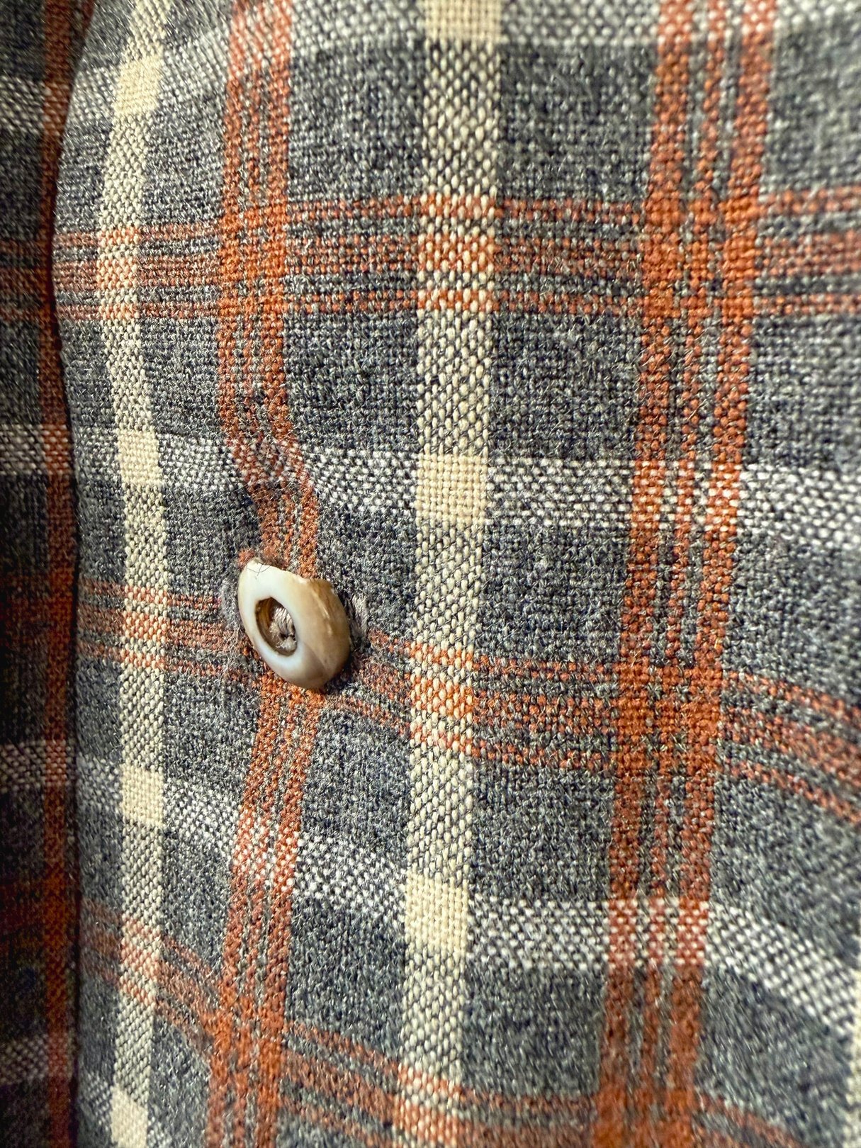 Men's 1950s Original Santa Cruzer of California plaid shirt featuring a grey fabric with orange and cream-check patterns and a distinctive button detail.