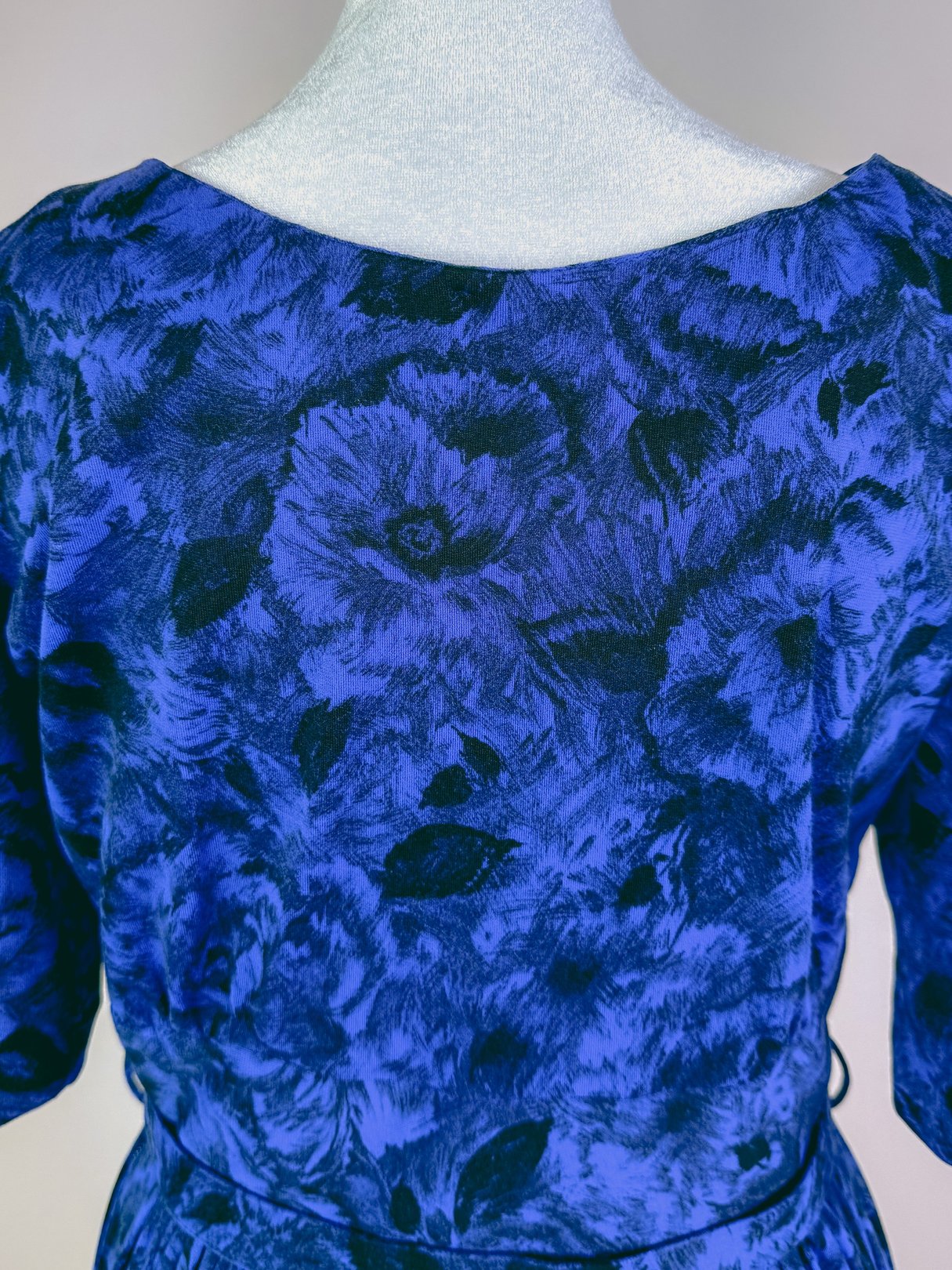Midnight blue 1960s women's dress featuring a floral pattern.