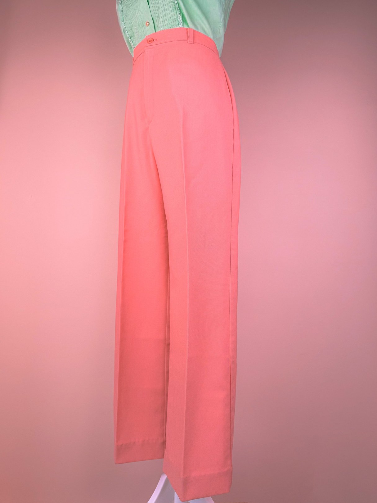 Coral pink 1970s women's pants with a wide-leg silhouette.