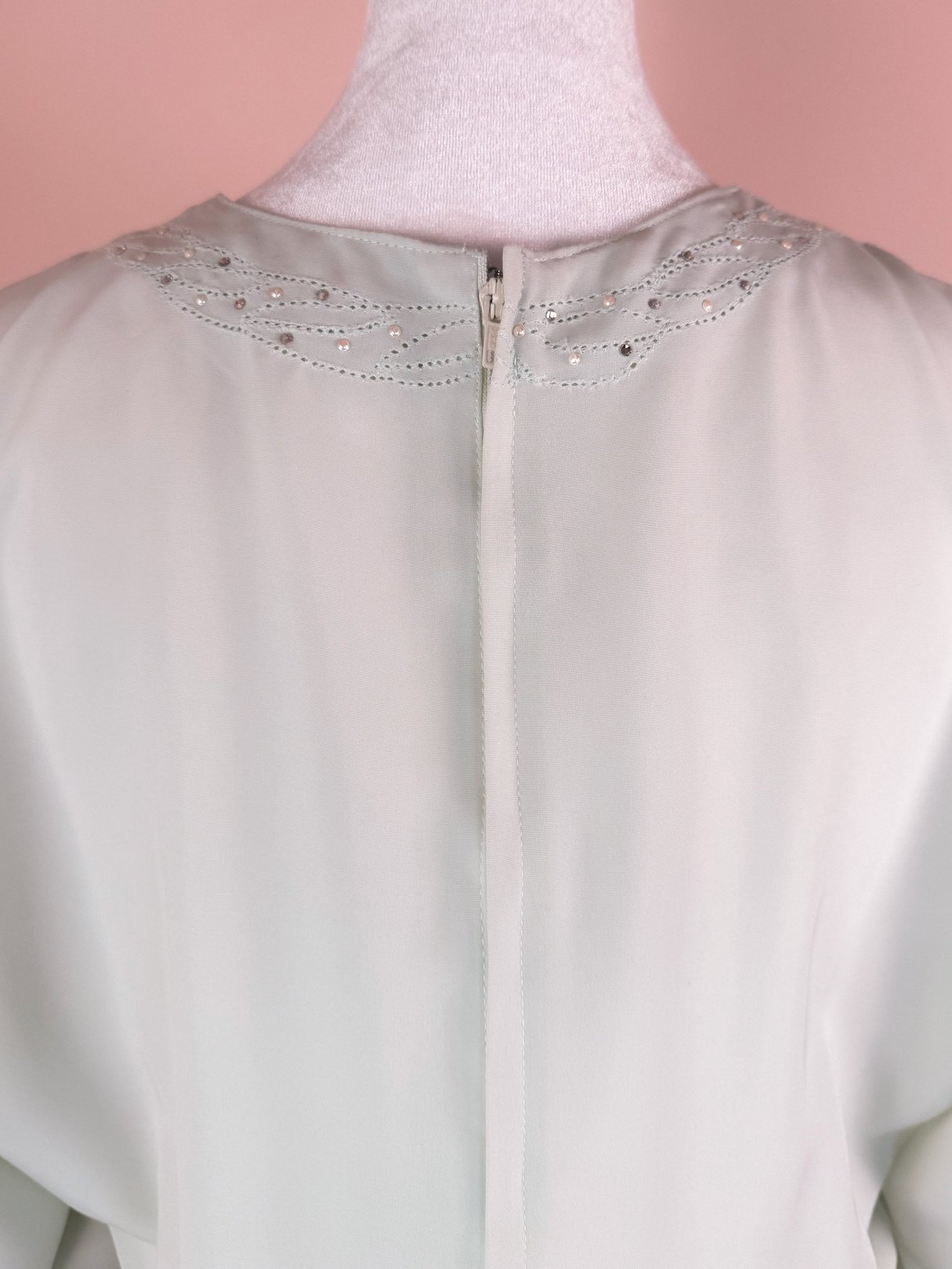 Mint green women's dress with a subtle sparkle, featuring a back zipper and 1980s design elements.