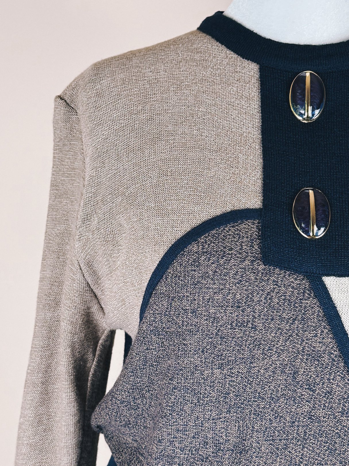 Navy blue and gray 1980s artist sweater dress for women featuring a textured upper and decorative buttons.